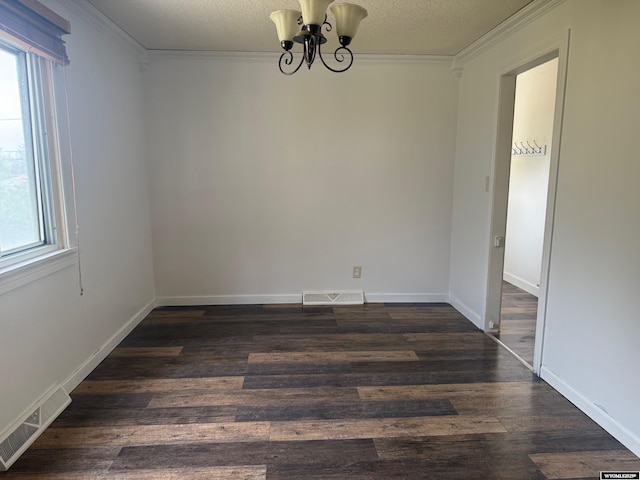 524 E Murray St, Rawlins, WY 82301 - empty room featuring a chandelier, crown molding, dark wood-style flooring, and a textured ceiling