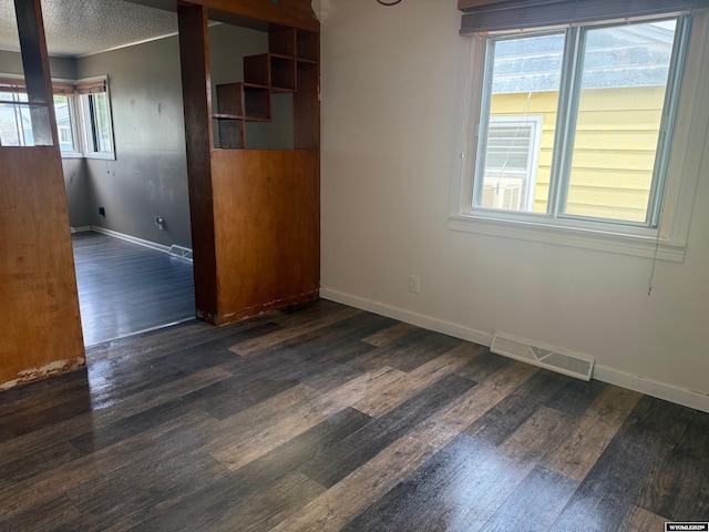 524 E Murray St, Rawlins, WY 82301 - spare room with dark wood-style flooring and a textured ceiling