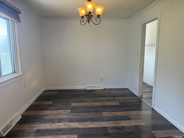 524 E Murray St, Rawlins, WY 82301 - empty room featuring a chandelier, crown molding, dark wood-type flooring, and a textured ceiling