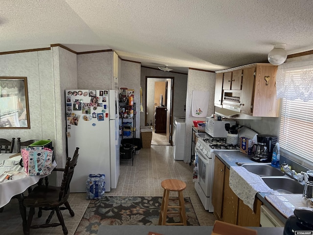 1700 Swanson # 89, Rock Springs, WY 82901 - kitchen featuring white appliances, a textured ceiling, ornamental molding, and washer / clothes dryer