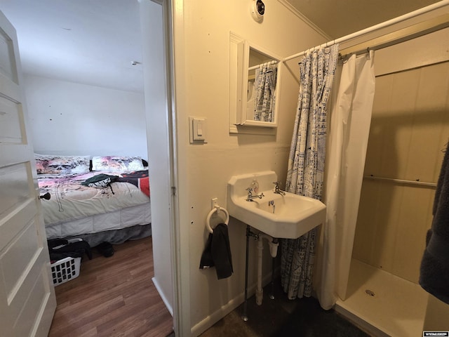 251 S Nebraska Ave, Guernsey, WY 82214 - bathroom featuring wood finished floors, curtained shower, and ensuite bath