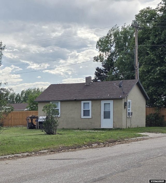 251 S Nebraska Ave, Guernsey, WY 82214 - view of front of home featuring stucco siding and roof with shingles