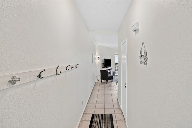 hall featuring light tile patterned floors