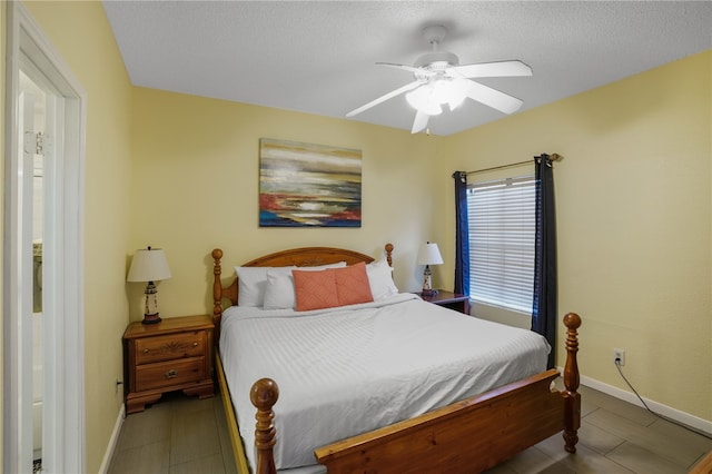 bedroom with a textured ceiling and ceiling fan