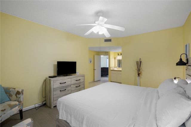 bedroom featuring ensuite bath and ceiling fan