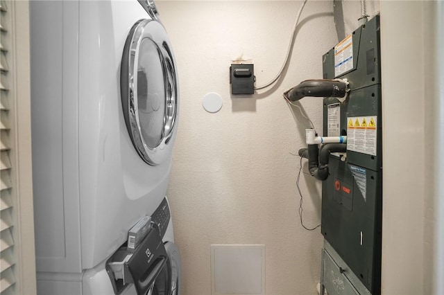 6317 State Highway 361 Unit 3311, Port Aransas, TX 78373 - laundry area with stacked washer and clothes dryer and heating unit