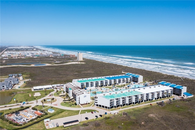 birds eye view of property with a water view and a beach view