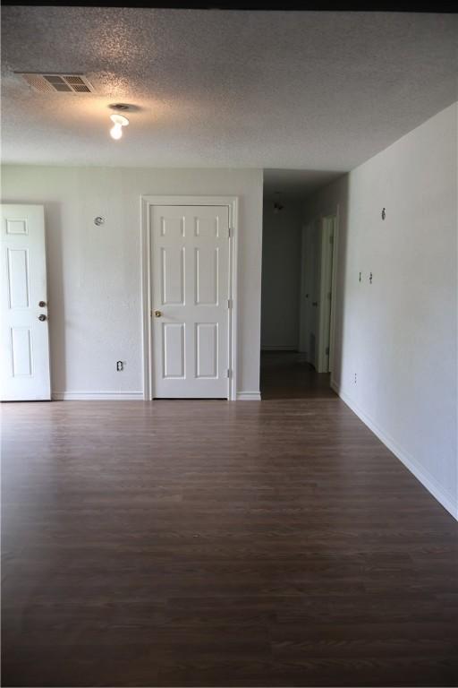 1905 Loritte Dr, Corpus Christi, TX 78416 - unfurnished room with dark wood-style flooring and a textured ceiling