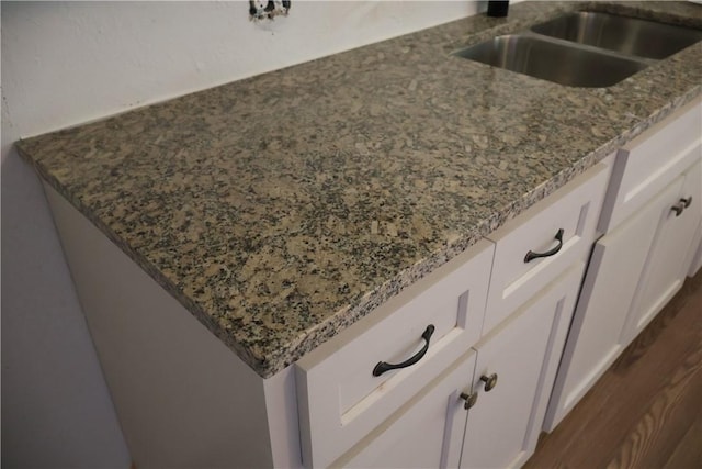 1905 Loritte Dr, Corpus Christi, TX 78416 - kitchen view of stone countertops, white cabinetry, and dark wood-style floors