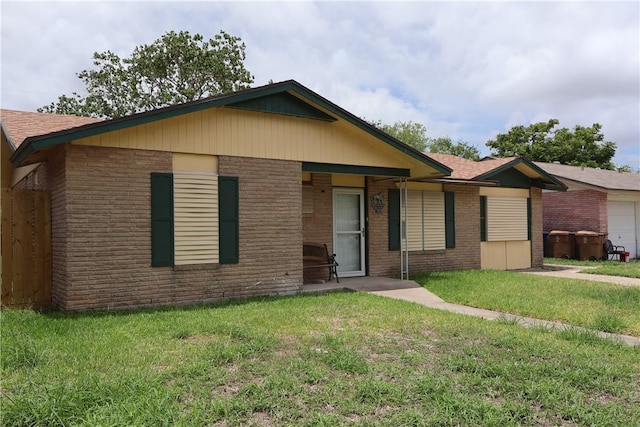 1905 Loritte Dr, Corpus Christi, TX 78416 - ranch-style home featuring brick siding, a front yard, and a shingled roof