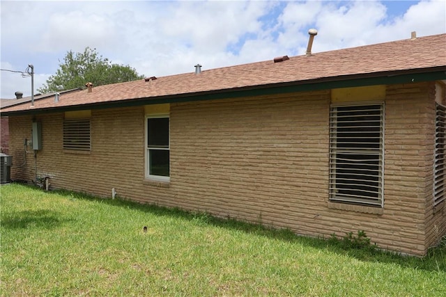 1905 Loritte Dr, Corpus Christi, TX 78416 - view of side of home with a lawn, brick siding, and a shingled roof