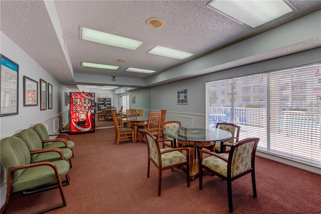 carpeted dining room featuring wainscoting and a textured ceiling