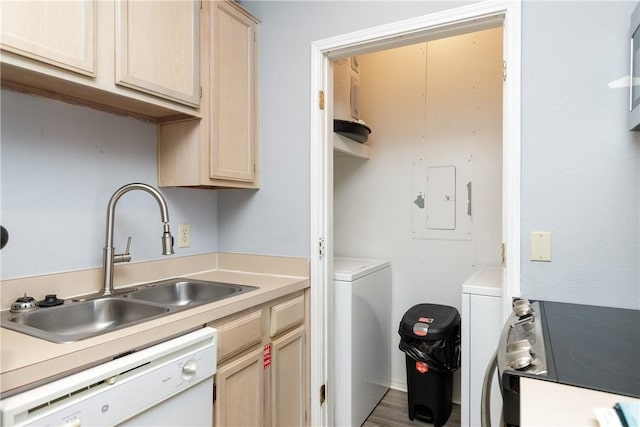 laundry room with laundry area, electric panel, wood finished floors, separate washer and dryer, and a sink