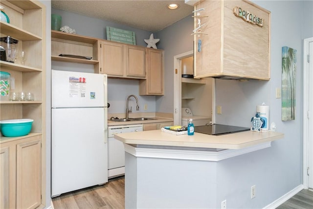 kitchen featuring light wood-style floors, white appliances, light brown cabinets, and a sink