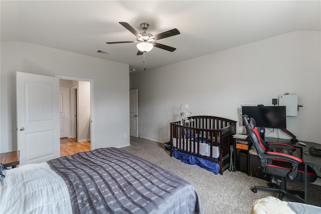 carpeted bedroom featuring lofted ceiling and ceiling fan