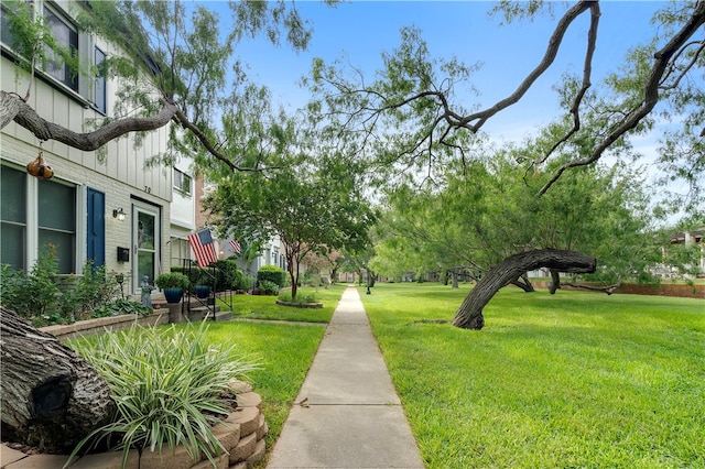 view of property's community with a lawn