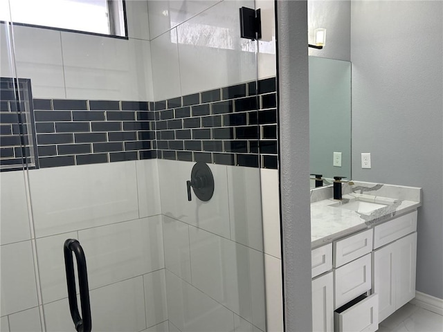 bathroom with walk in shower and vanity