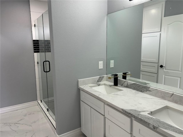 bathroom with vanity and a shower with shower door