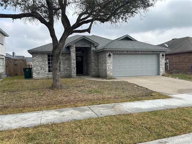 view of front of house featuring a garage and a front yard