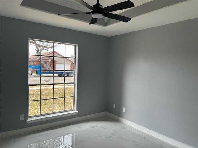 unfurnished room with a tray ceiling and ceiling fan