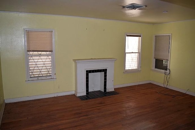 unfurnished living room with dark hardwood / wood-style floors and a tile fireplace