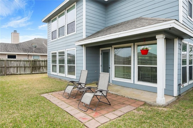 back of house featuring a patio and a yard