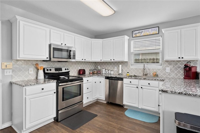 kitchen with white cabinetry, stainless steel appliances, sink, and dark wood-type flooring