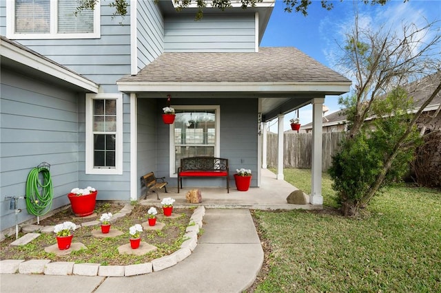 view of exterior entry featuring a lawn