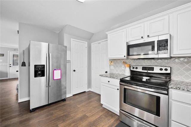 kitchen featuring light stone counters, appliances with stainless steel finishes, and white cabinets