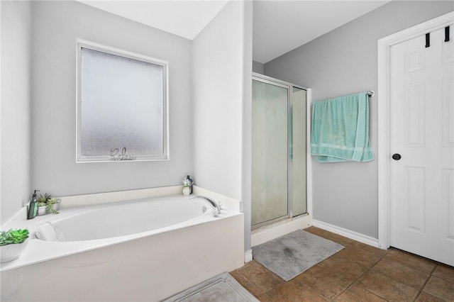 bathroom with tile patterned floors and shower with separate bathtub