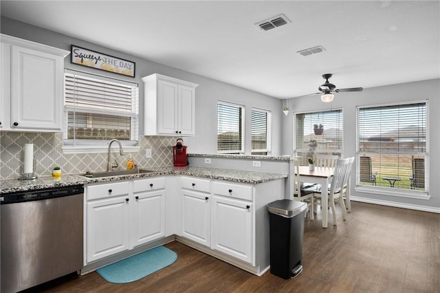 kitchen featuring sink, tasteful backsplash, dark hardwood / wood-style floors, dishwasher, and white cabinets