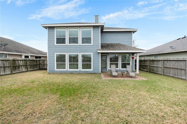 back of house with a patio and a yard