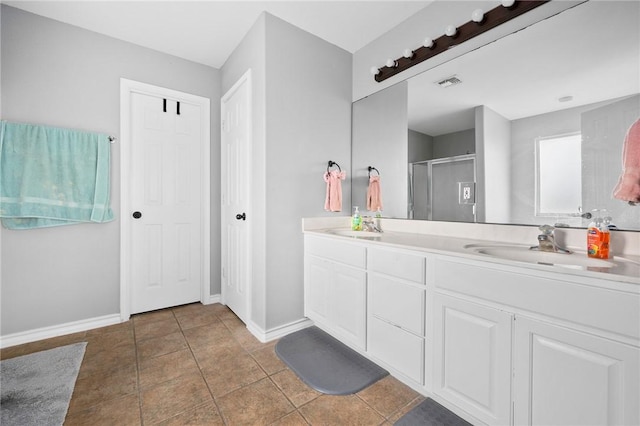 bathroom featuring vanity, tile patterned flooring, and a shower with door