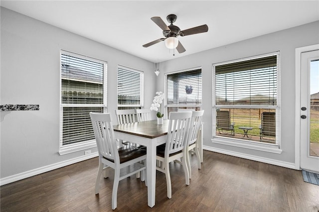 dining space with ceiling fan and dark hardwood / wood-style flooring