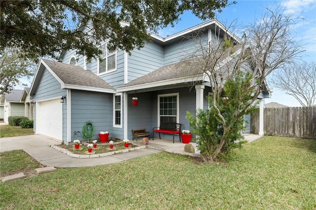 view of front of property featuring a porch, a garage, and a front yard