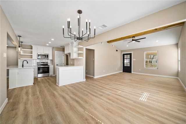 kitchen with open shelves, tasteful backsplash, open floor plan, and appliances with stainless steel finishes