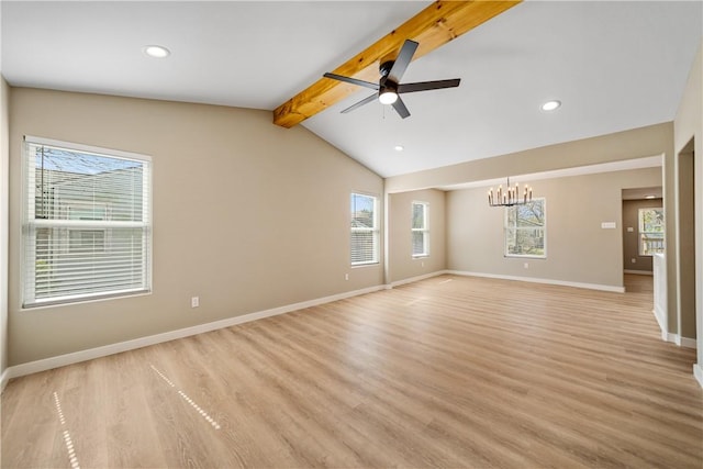 spare room featuring ceiling fan with notable chandelier, lofted ceiling with beams, light wood-style floors, and baseboards