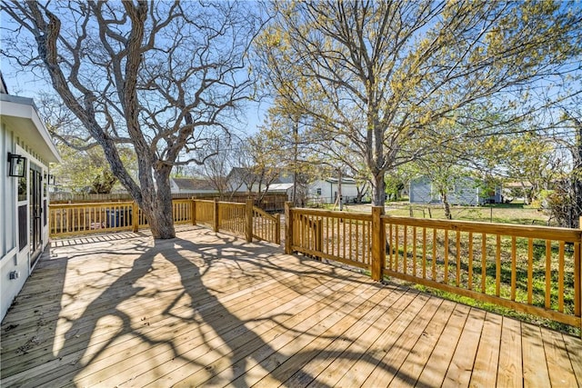 wooden terrace with a residential view and a fenced backyard