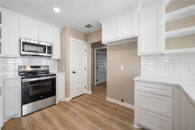 kitchen featuring open shelves, white cabinets, visible vents, and appliances with stainless steel finishes