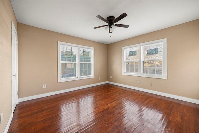 empty room with ceiling fan and dark hardwood / wood-style floors