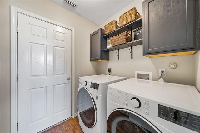 7217 Dunns Point Dr, Corpus Christi, TX 78414 - laundry area featuring independent washer and dryer, cabinet space, and wood finished floors