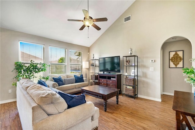 7217 Dunns Point Dr, Corpus Christi, TX 78414 - living area with ceiling fan, high vaulted ceiling, arched walkways, and light wood-style flooring