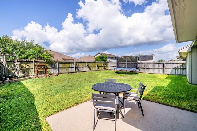 7217 Dunns Point Dr, Corpus Christi, TX 78414 - fenced backyard featuring a patio, a trampoline, and outdoor dining space