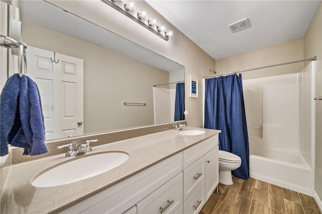7217 Dunns Point Dr, Corpus Christi, TX 78414 - full bathroom with double vanity, shower / bath combo, and wood finished floors