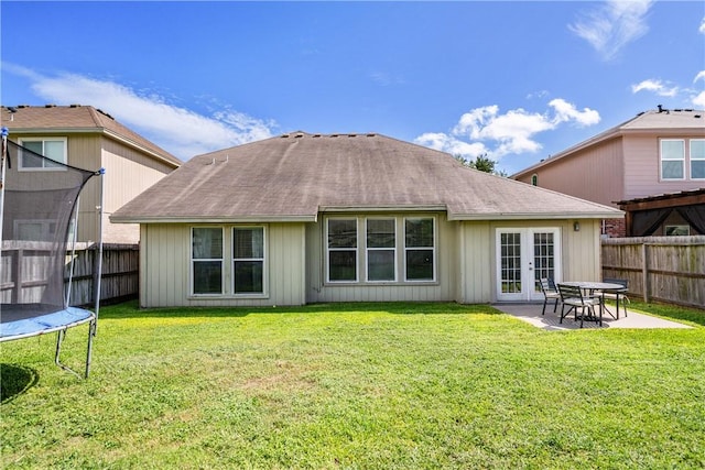 7217 Dunns Point Dr, Corpus Christi, TX 78414 - rear view of property featuring a trampoline, french doors, a patio, and roof with shingles