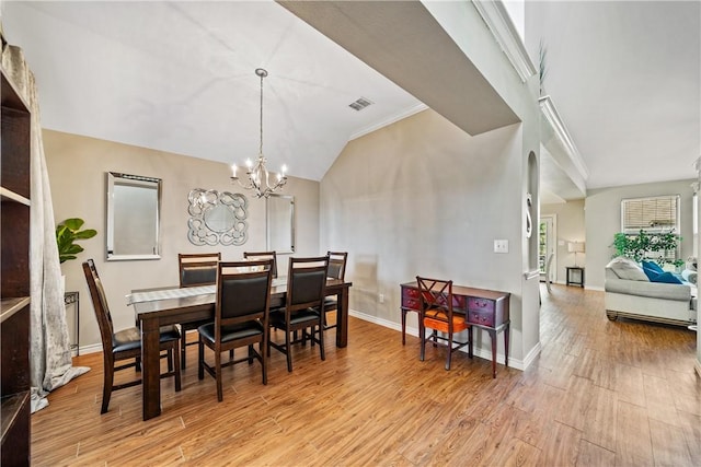 7217 Dunns Point Dr, Corpus Christi, TX 78414 - dining room featuring wood finished floors, a chandelier, and lofted ceiling
