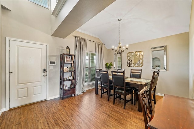 7217 Dunns Point Dr, Corpus Christi, TX 78414 - dining room featuring a chandelier, wood finished floors, and vaulted ceiling