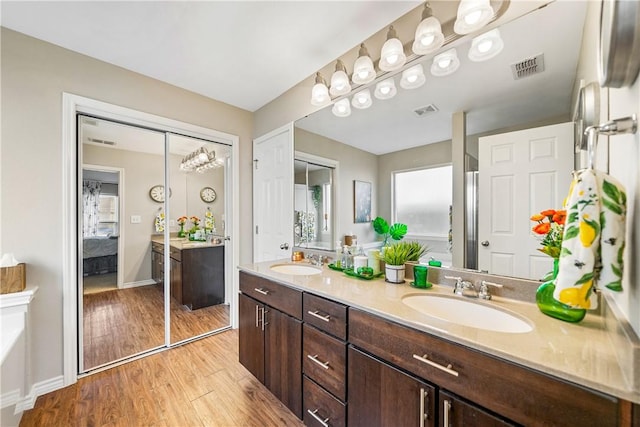 7217 Dunns Point Dr, Corpus Christi, TX 78414 - ensuite bathroom featuring double vanity, wood finished floors, and a tub