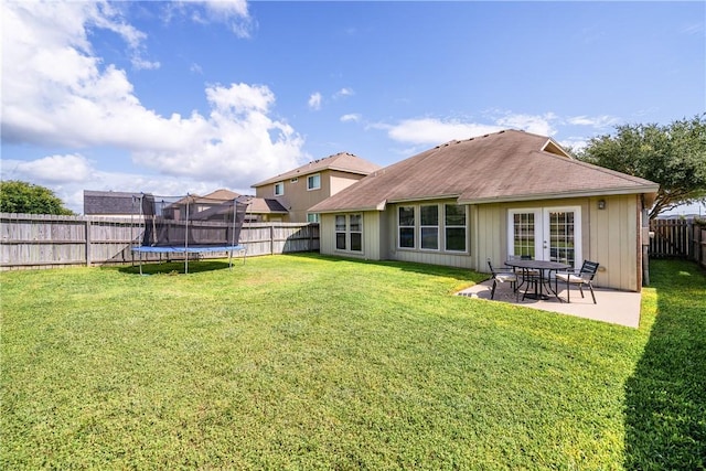7217 Dunns Point Dr, Corpus Christi, TX 78414 - back of property featuring a trampoline, a fenced backyard, a patio area, and french doors
