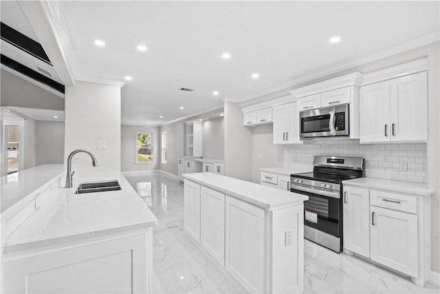 6417 Coral Gables Dr, Corpus Christi, TX 78413 - kitchen with stainless steel appliances, a center island, light marble finish floors, recessed lighting, and ornamental molding